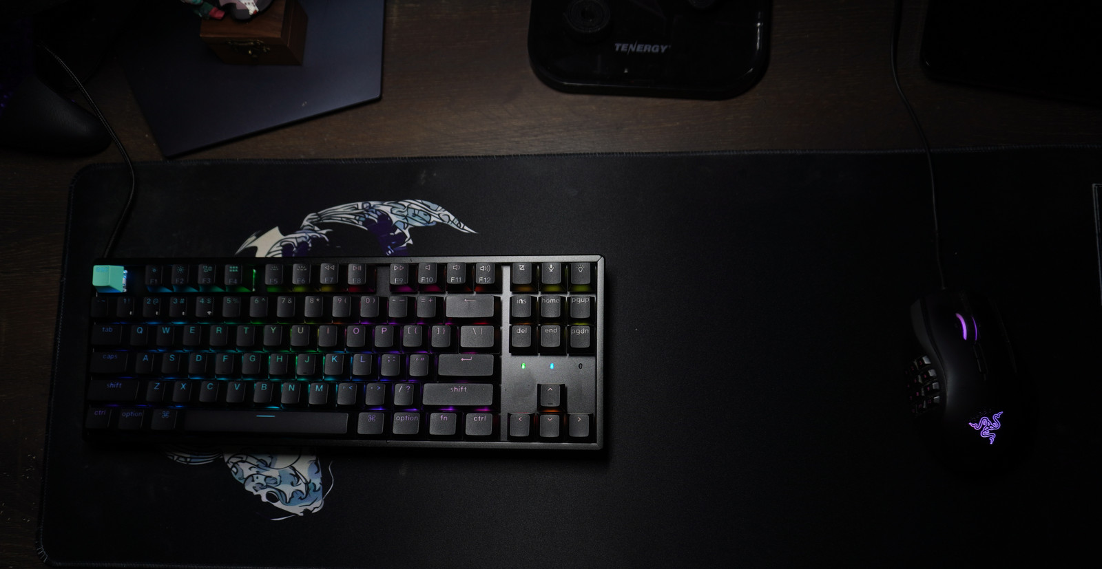 Overhead view of the complete Keychron K8 HE on the left of a large desk mat, with a Razer mouse on the right and open space between them.