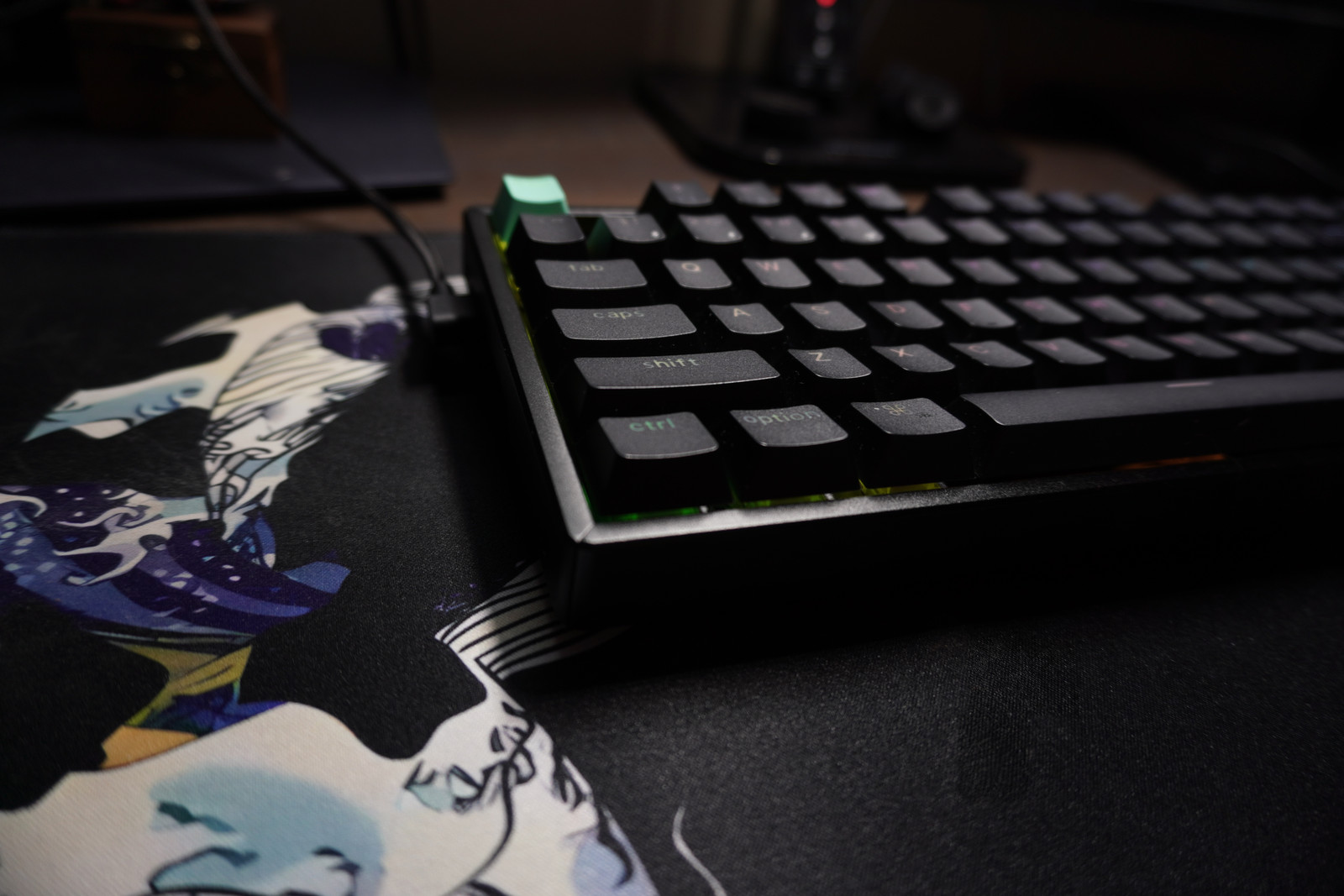 Low-angle close-up of the left-hand keycaps, their curved tops, and the front edge of the K8 HE.